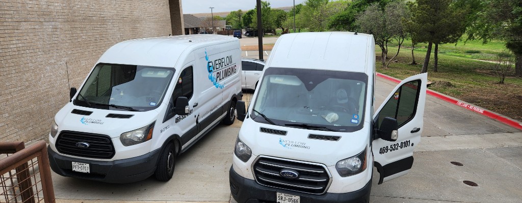 Two Everflow Plumbing service vans parked and ready for dispatch in North Texas